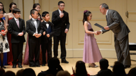 Carolyne Yu in Carnegie Hall, New York, receiving a Diploma of  Protégé Competition Winner